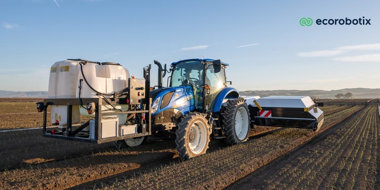Bild ARA von Ecorobotix und einem Blauen Newholland Traktor auf dem Feld